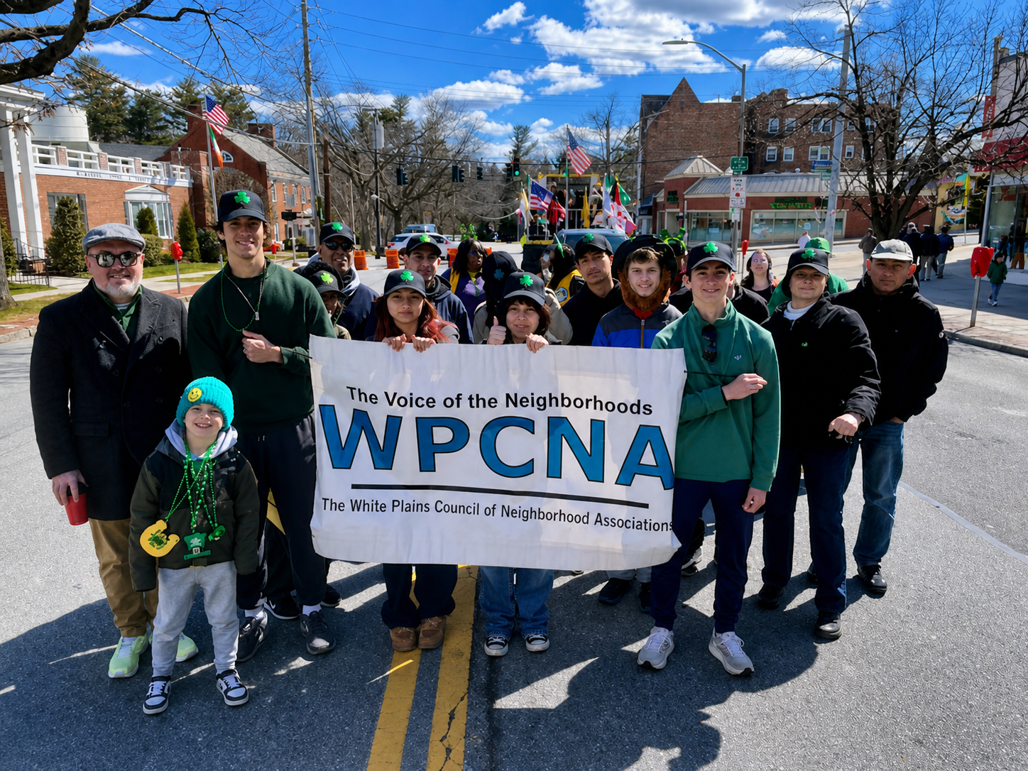 WPCNA members and neighbors holding a WPCNA banner during a White Plains parade.